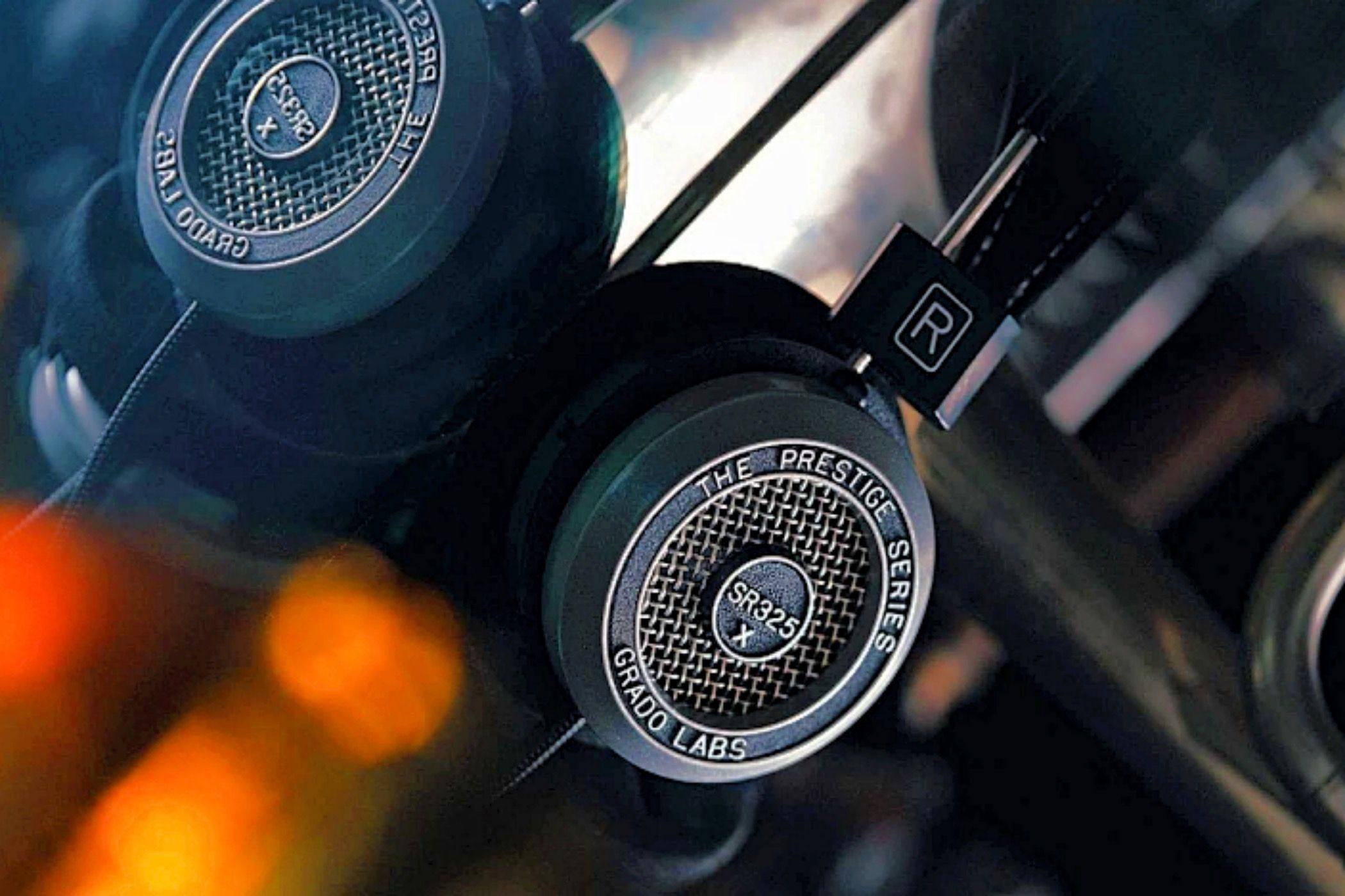 The Grado SR325x headphones reflecting on glass.