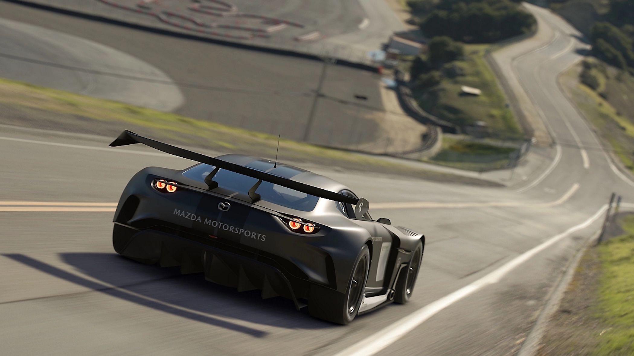 A black car driving down an open road in Gran Turismo 7.