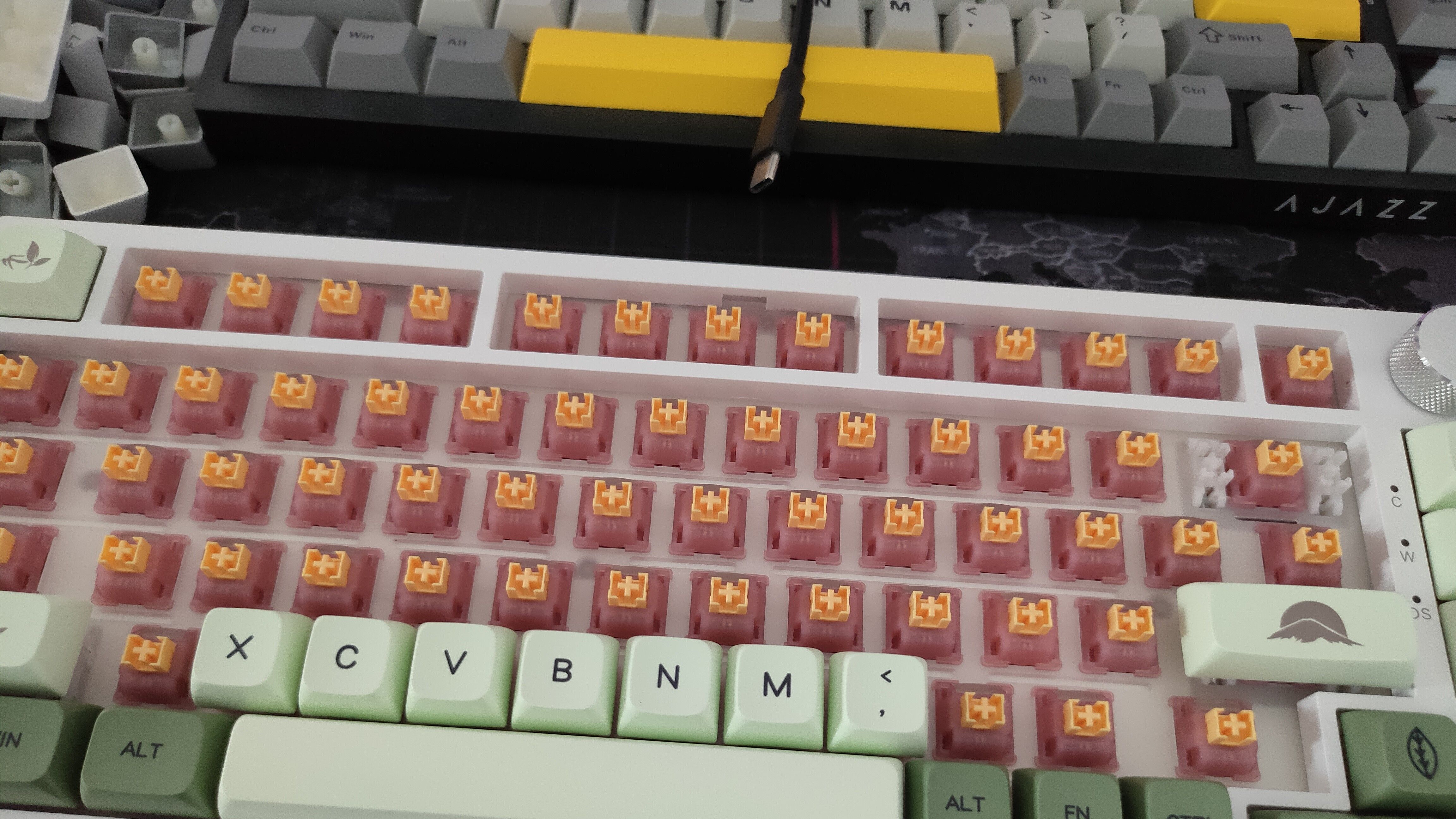 The Outemu Silent Peach V3 switches mounted on a white keyboard with green keycaps.