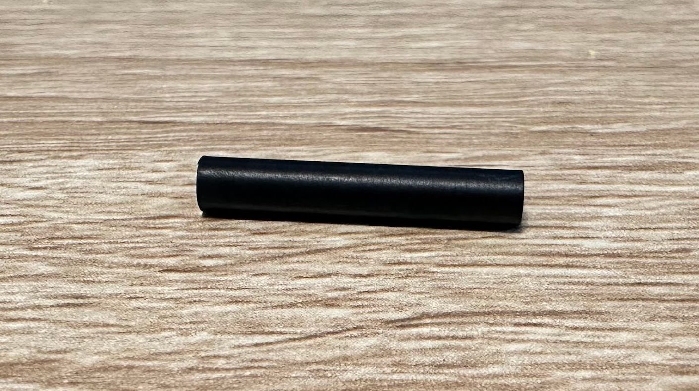 A small plastic pipe used to guide extruder filament in the Creality K1 Max 3D printer.