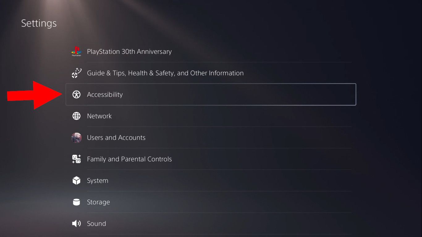 A red arrow pointing to the accessibility menu in the PS5 system settings.