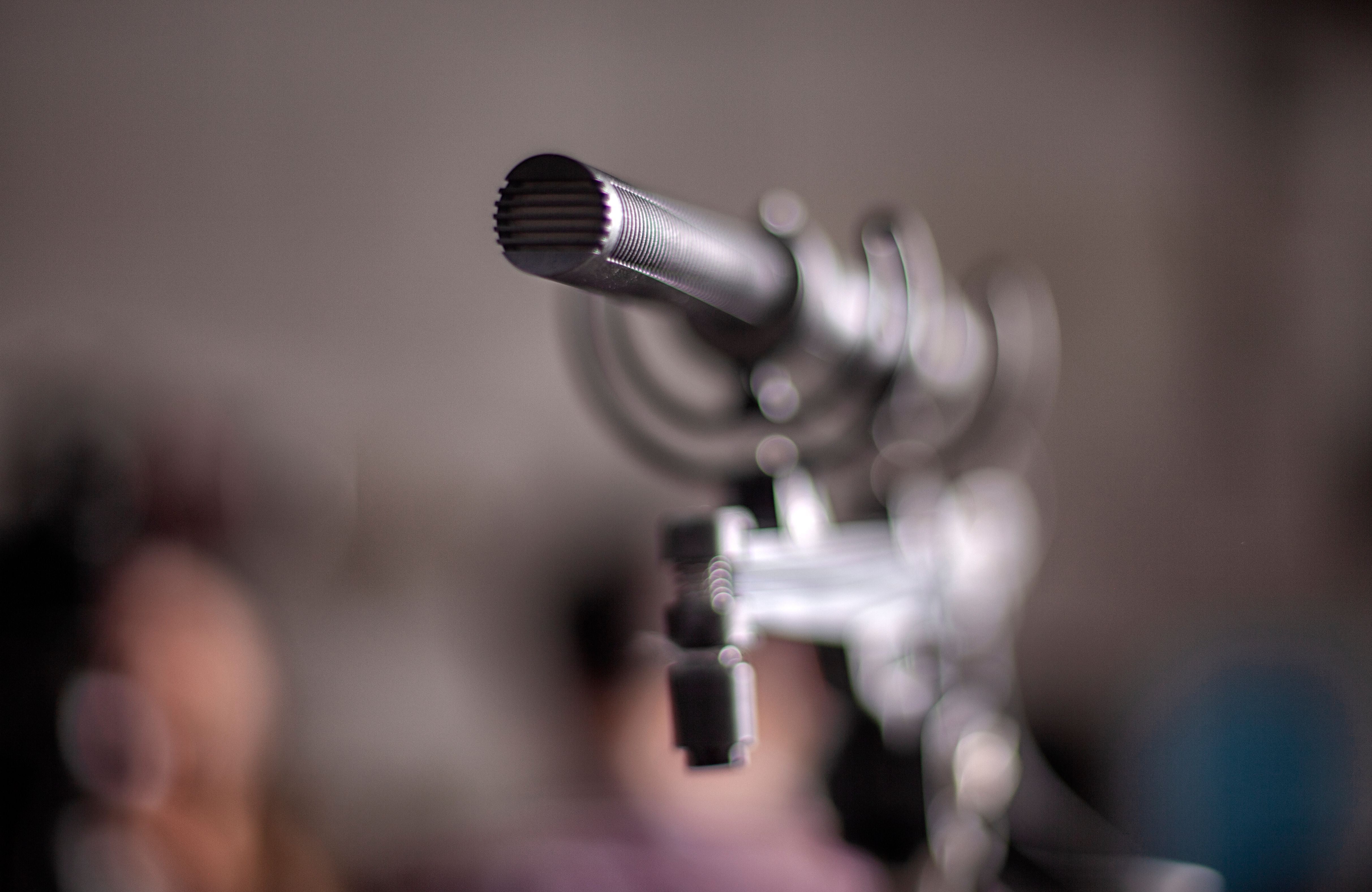 Shotgun microphone with blurred background.