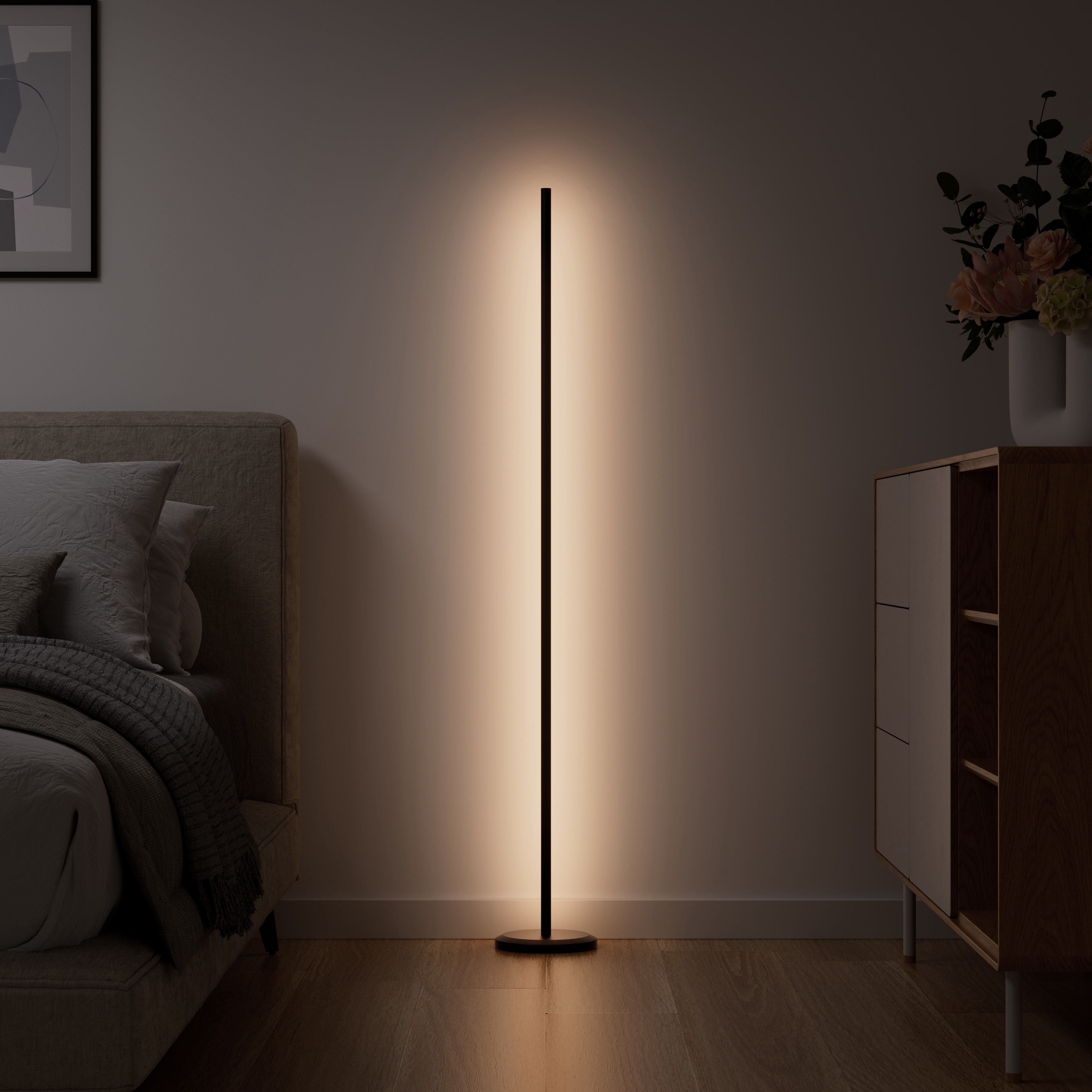 Nanoleaf's floor lamp in a bedroom, emitting a white ambient light.