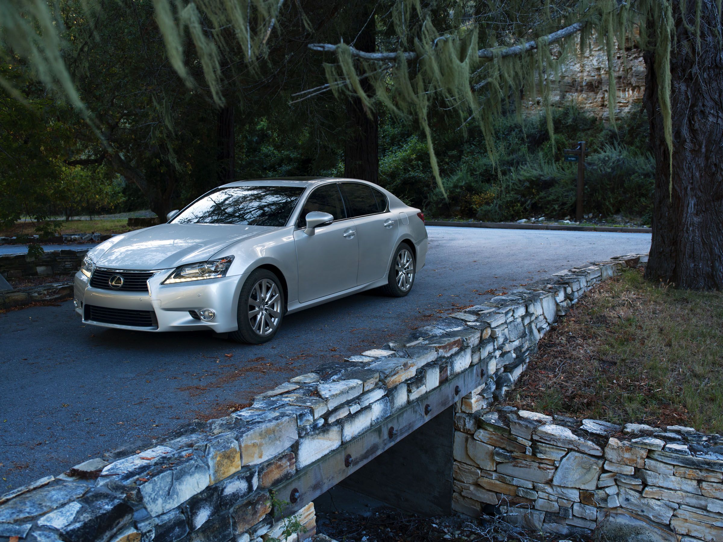 A silver 2014 Lexus Gs 350 parked on a stone bridge.