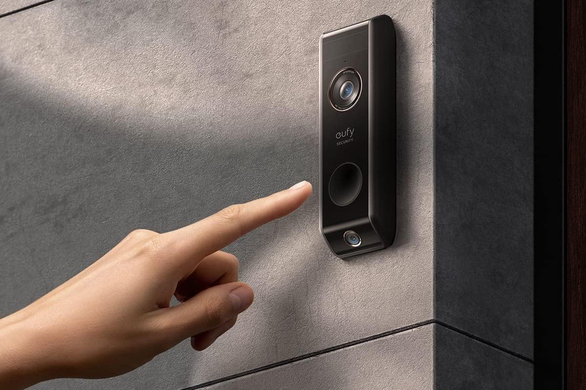 a hand ready to press the button on a eufy security video doorbell