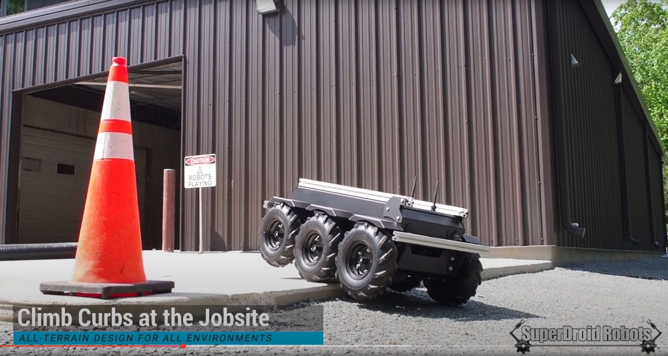 A screencap of the HK1500 autonomous hauling robot mantling an curb.