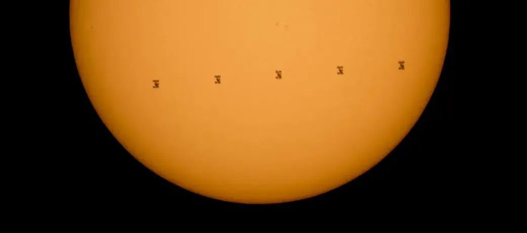 A sequence of photos showing the transit of the ISS across the Sun.