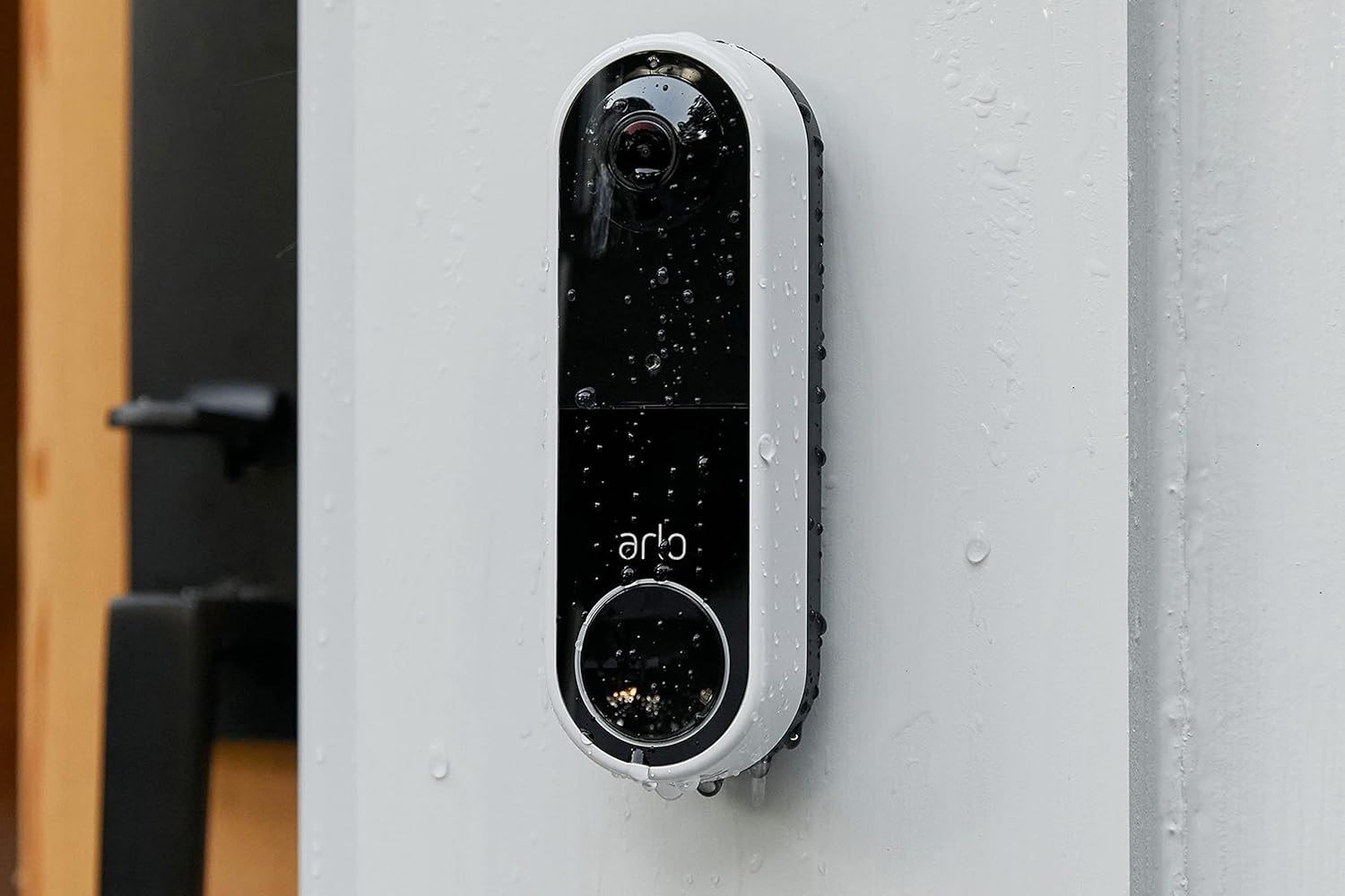 arlo essential video doorbell covered in rain