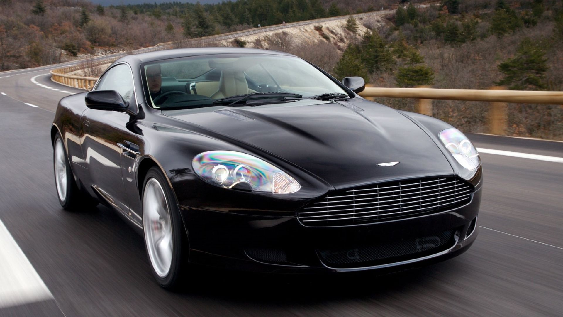 Front 3/4 action shot of a 2007 Aston Martin DB9 