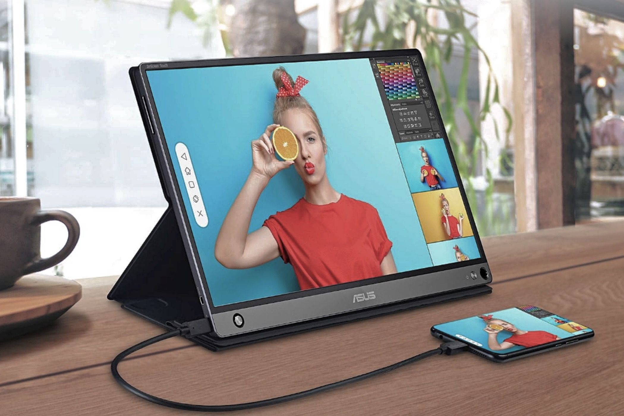 The ASUS ZenScreen Touch (MB16AMT) portable monitor displaying a colorful image of a woman.