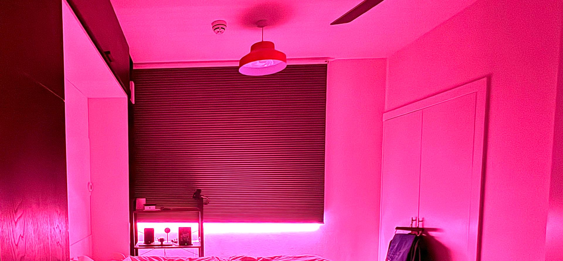 Color lighting is never the wrong decision. Pink lighting in a bedroom.