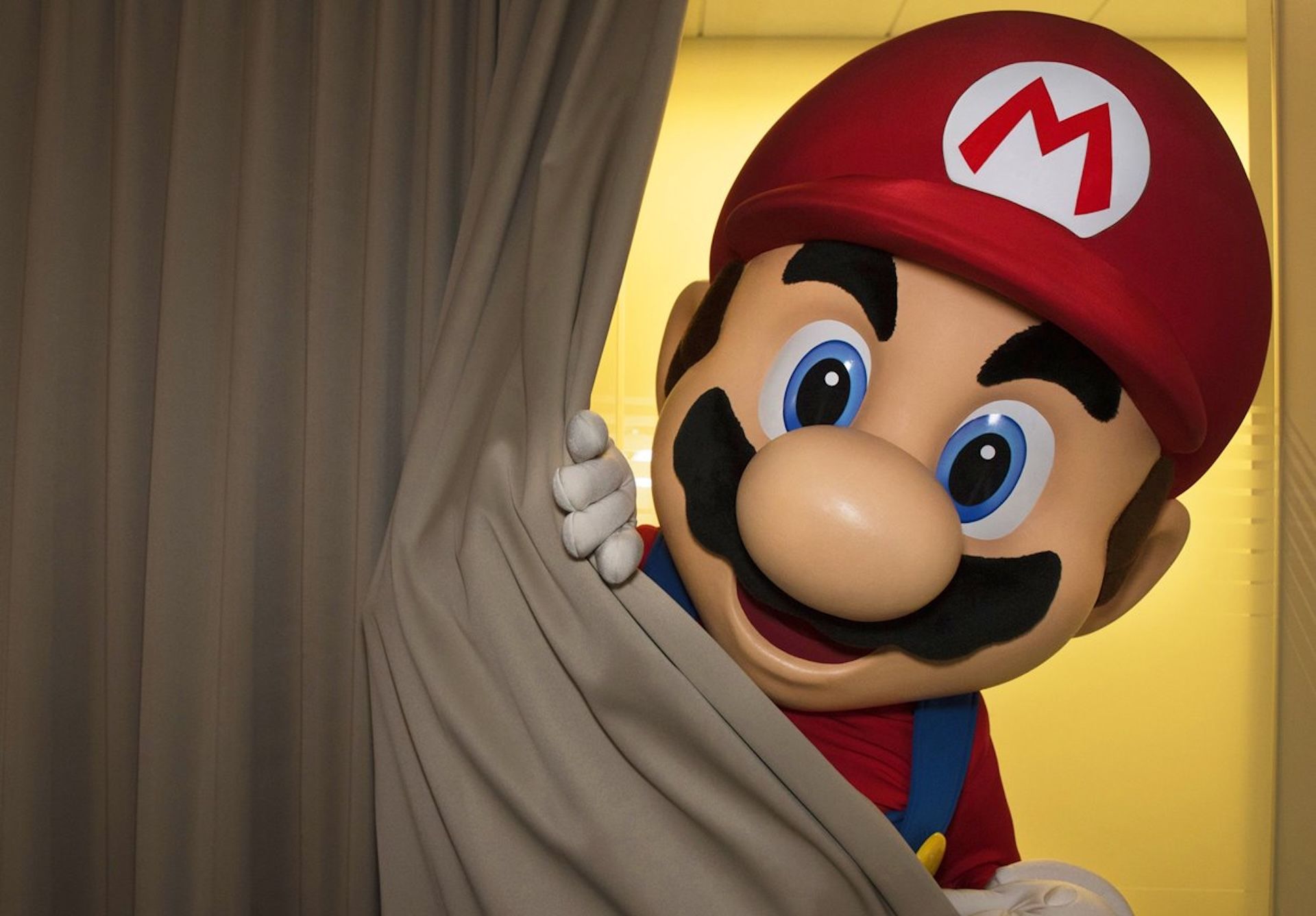 A creepy Mario peeking out from behind a curtain.