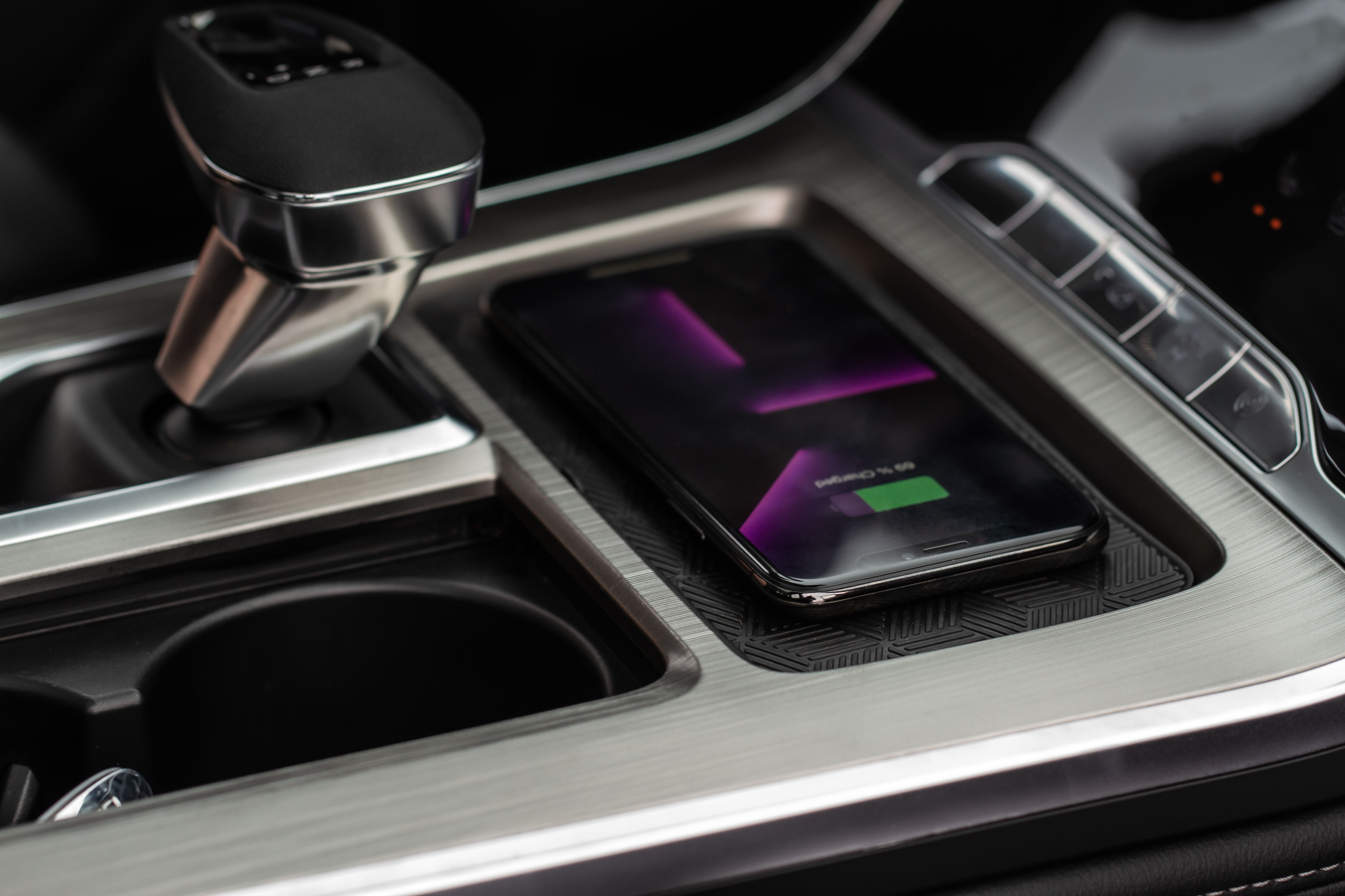 Close-up shot of a wireless mobile charger in a modern car.