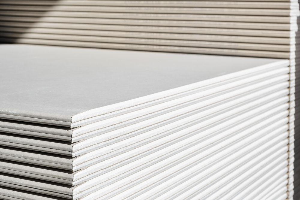 A stack of white drywall Standard Gypsum board panel.