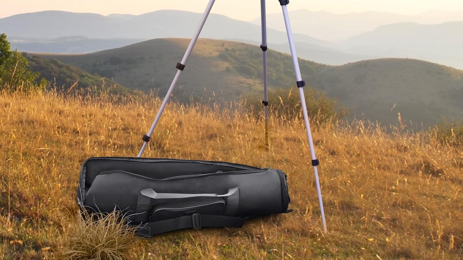 A USA Gear refractor telescope carrying case on the ground next to a telescope.