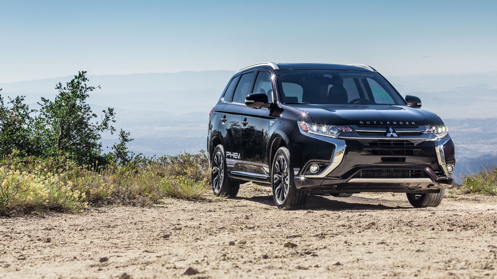 Front view of black 2018 Mitsubishi Outlander PHEV parked on gravel.