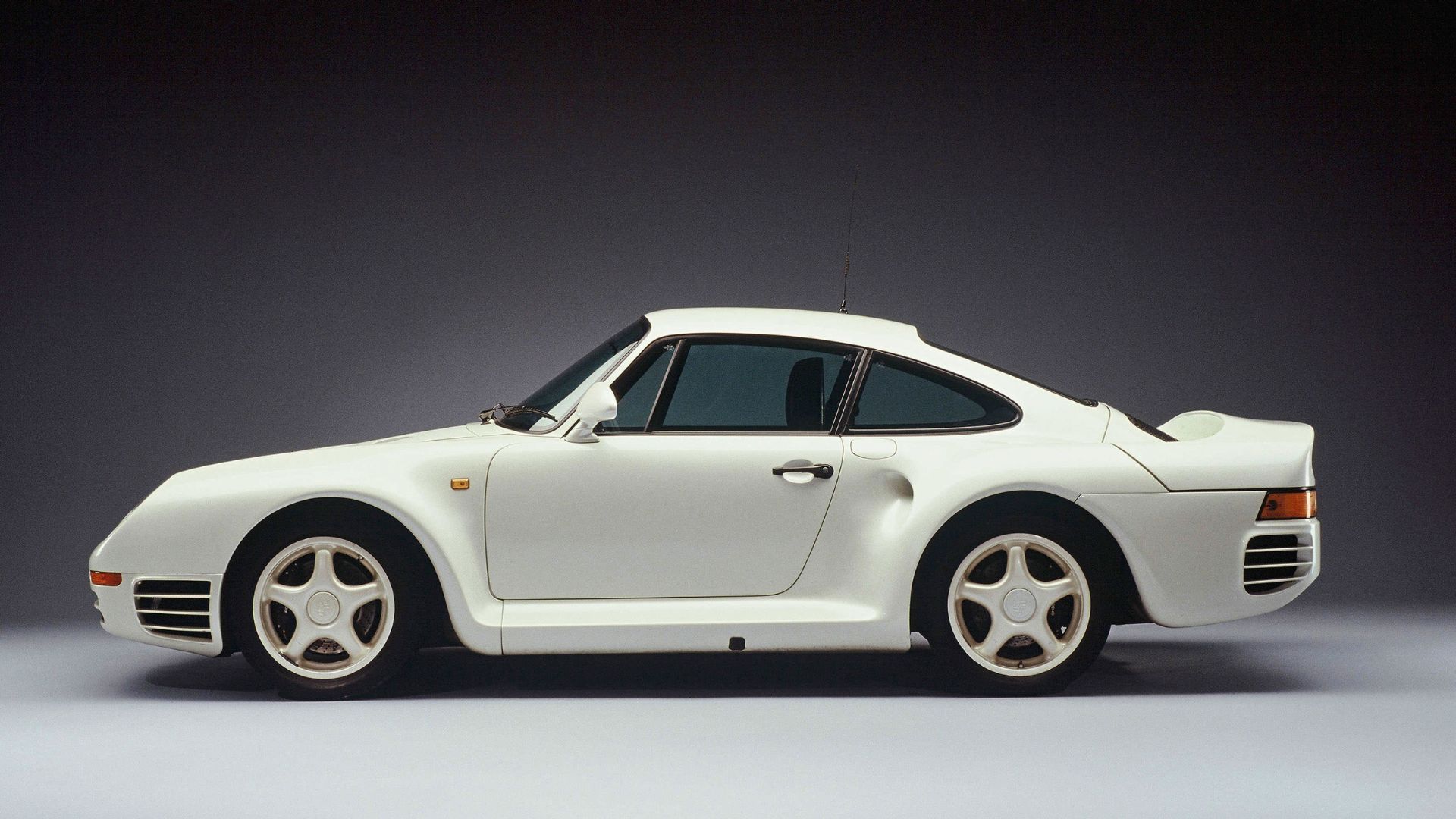 Side profile of a white 1985 Porsche 959.