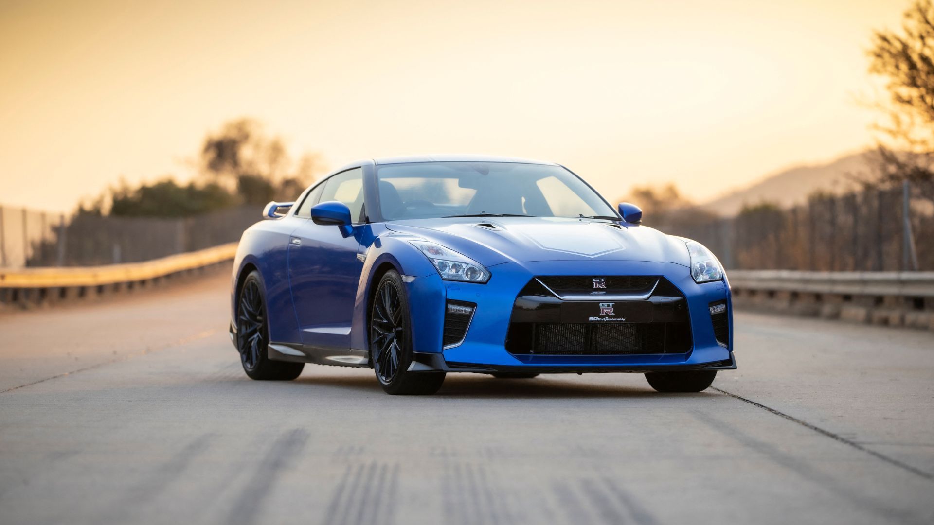 Blue 2020 Nissan GT-R 50th Anniversary Edition parked on an angle on tarmac.