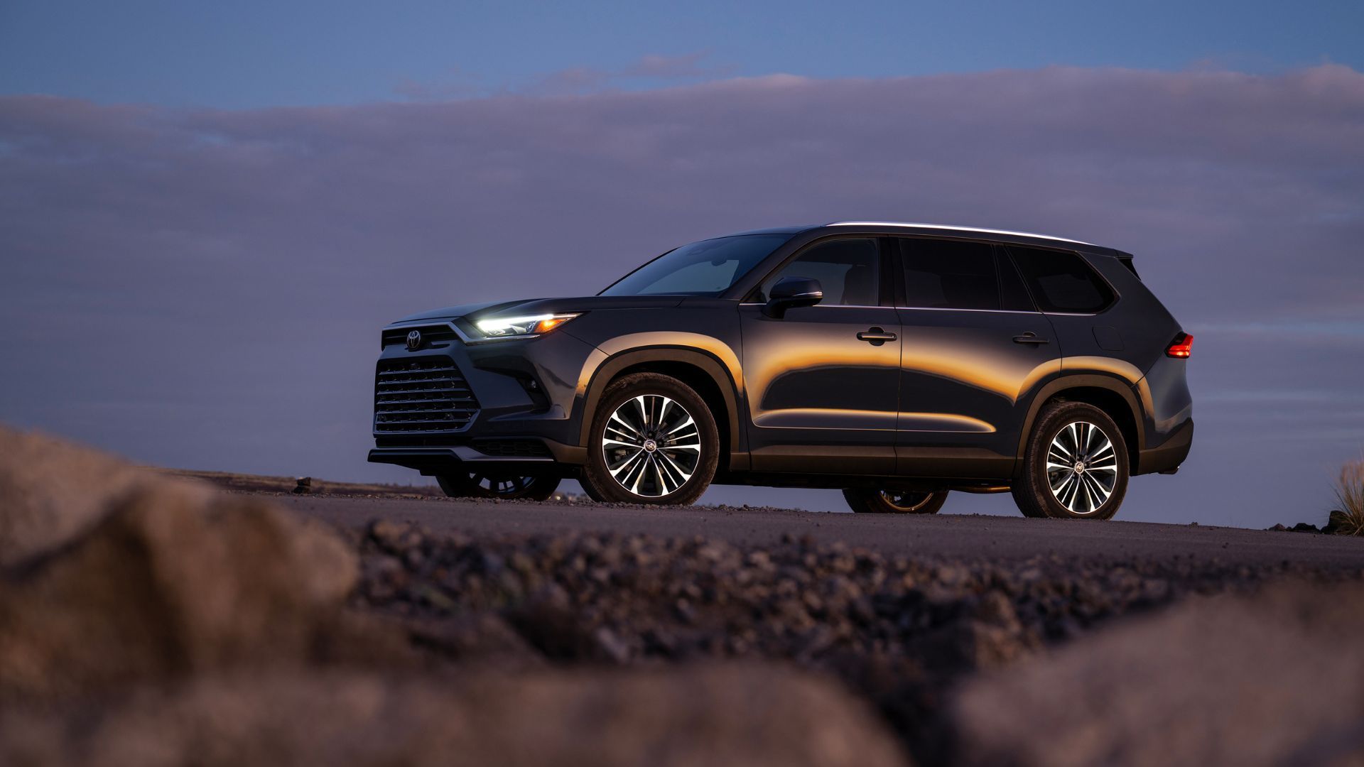 Side profile of a black 2025 Toyota Grand Highlander.