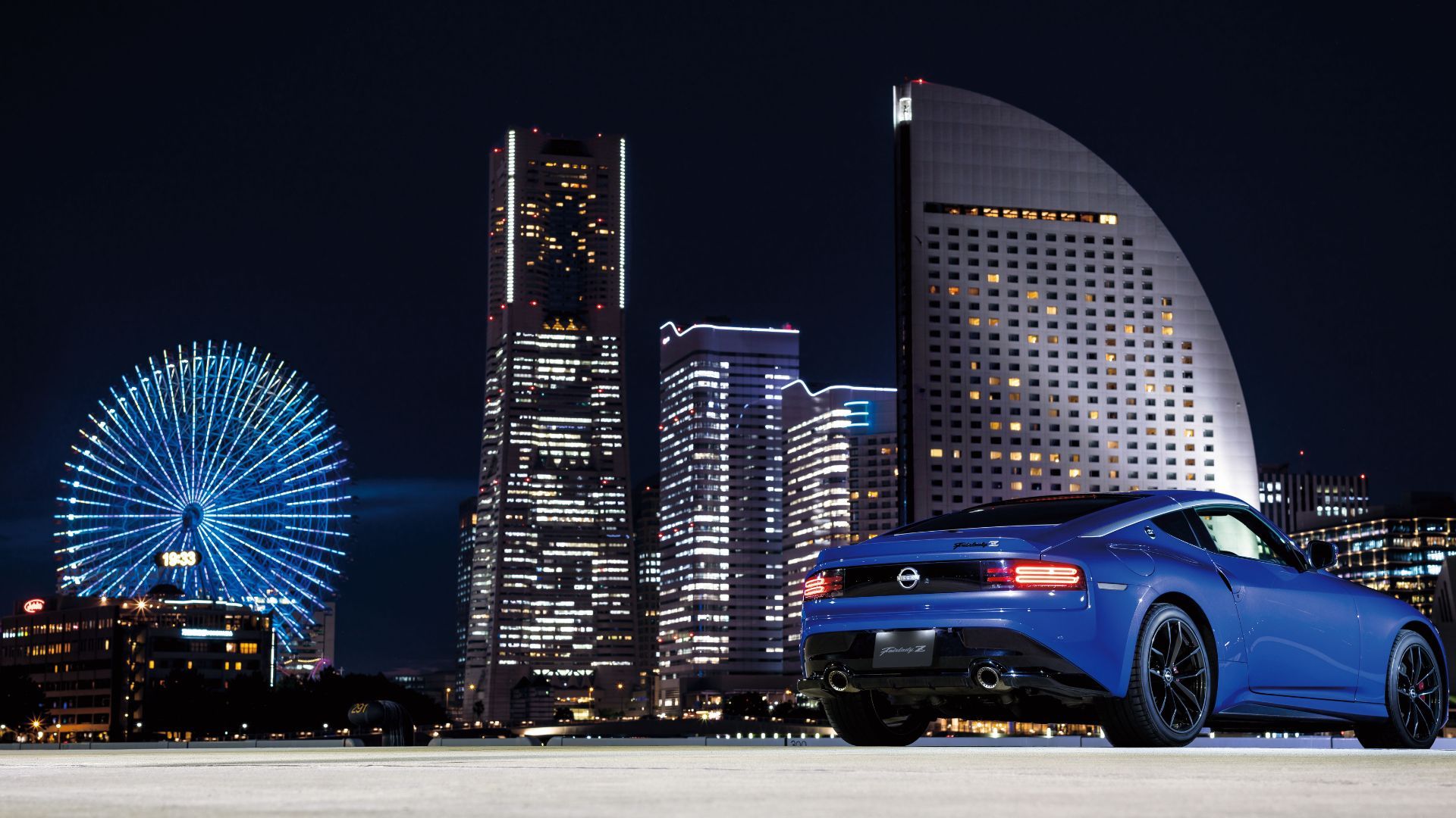 Rear view of blue Nissan Fairlady Z with skyscrapers in the background.