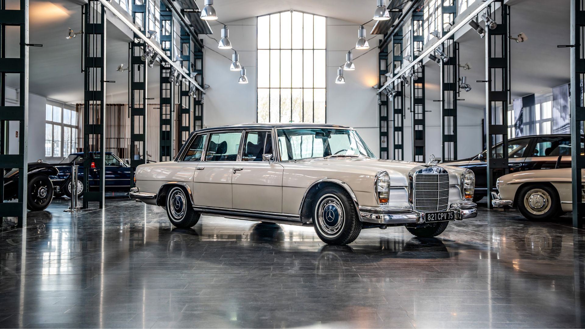 Full view of a white 1971 Mercedes-Benz 600 pictures indoors as part of a collection.