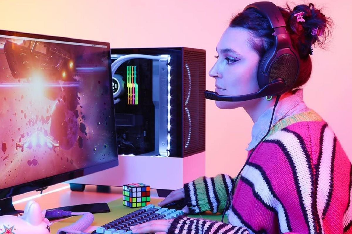 A person playing a video game, while wearing the Drop + EPOS PC38X gaming headset