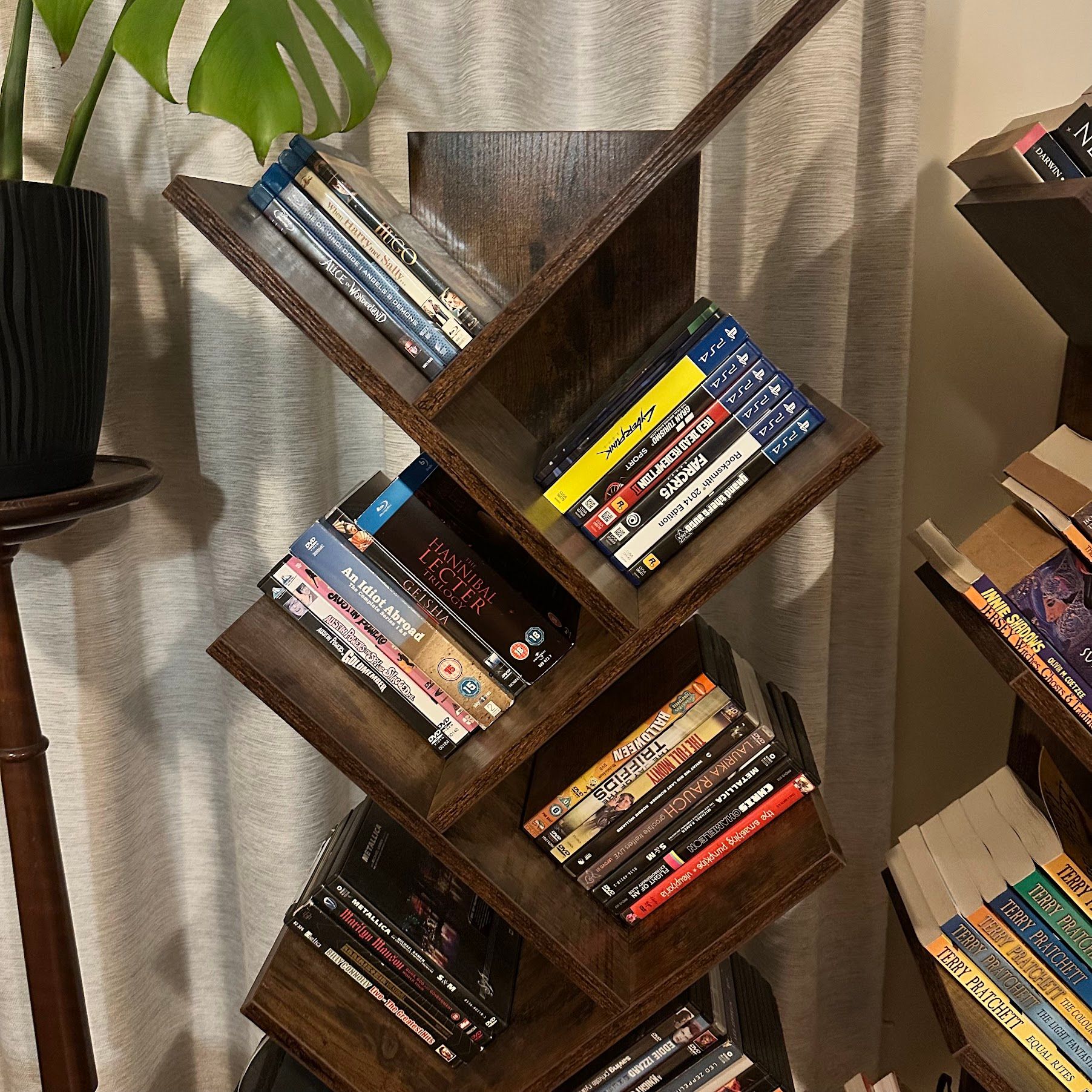 A stylish bookshelf with DVD and Blu-ray movies.