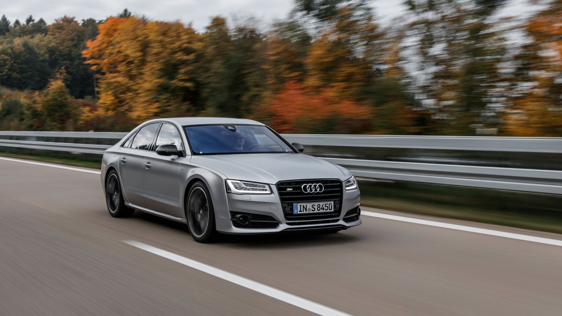 Full view of a silver 2015 Audi S8 Plus driving on a highway.