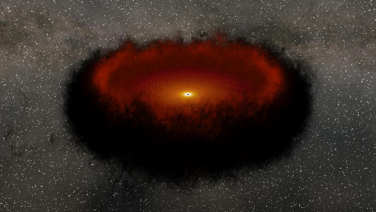 A supermassive black hole surrounded by a disk of material called an accretion disk.