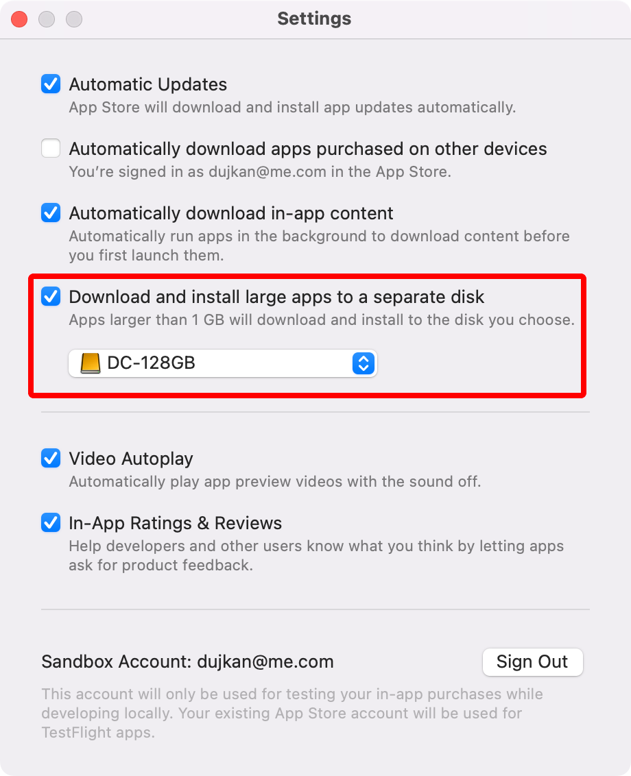 Mac App Store settings on macOS Sequoia 15.3 with the option to download large apps to a separate disk enabled and annotated.