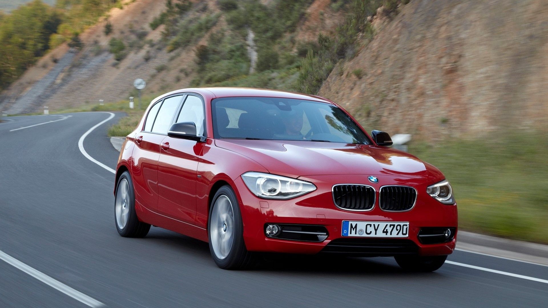 Front 3/4 action shot of a 2012 BMW 1-Series