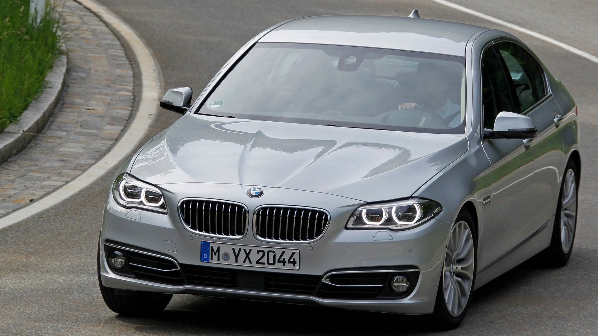 Front 3/4 action shot of a 2014 BMW 5-Series