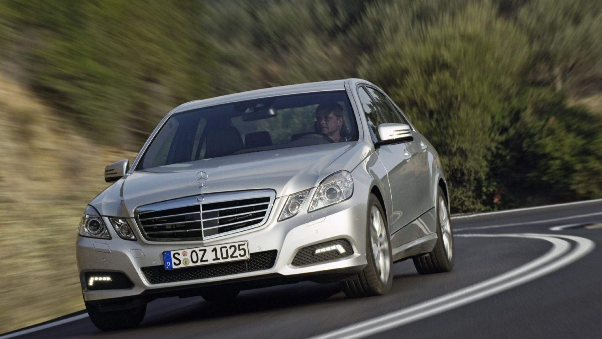 Front 3/4 action shot of a 2010 Mercedes-Benz E-Class