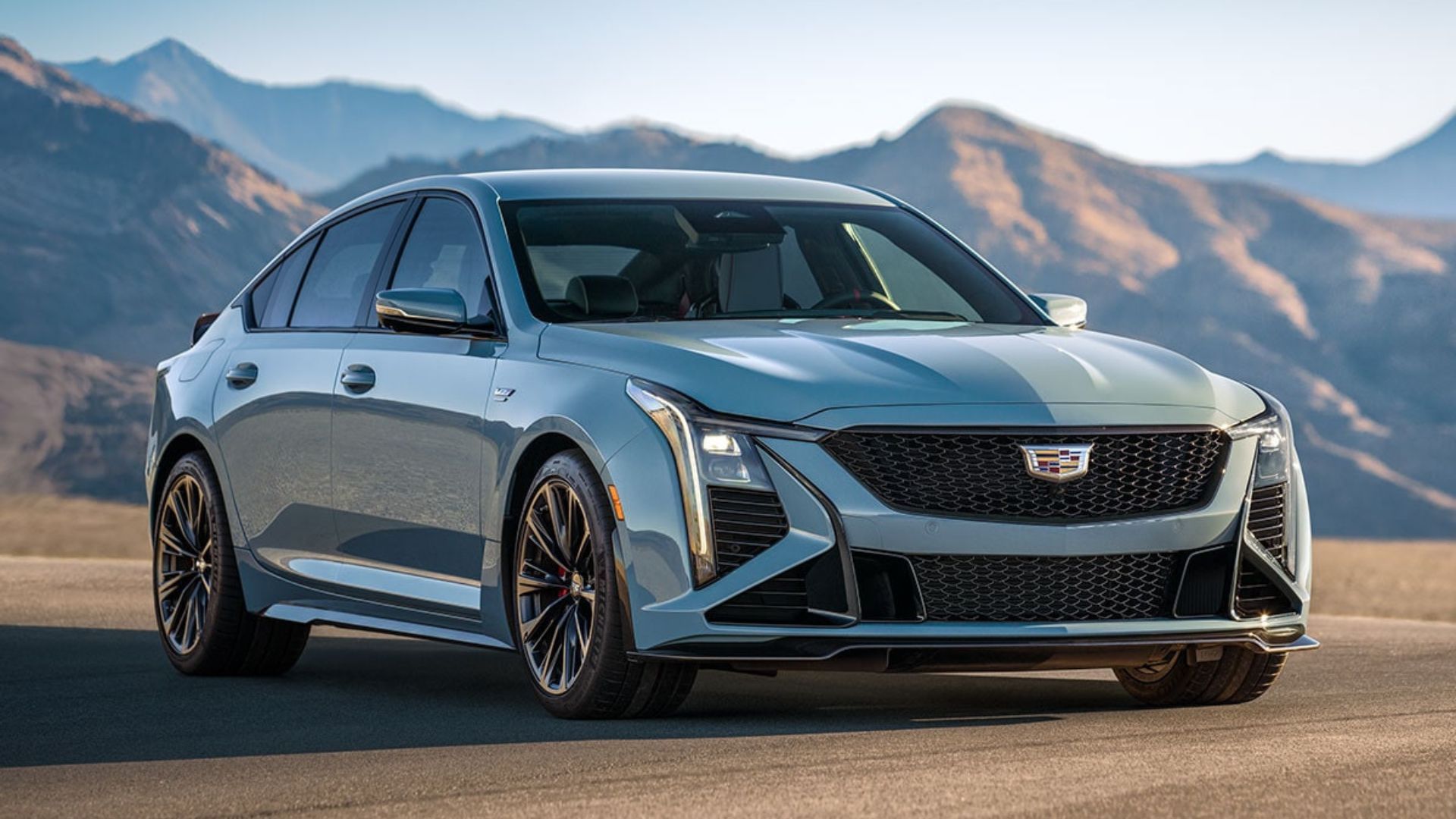 Full view of gray Cadillac CT5-V with mountains in the background.