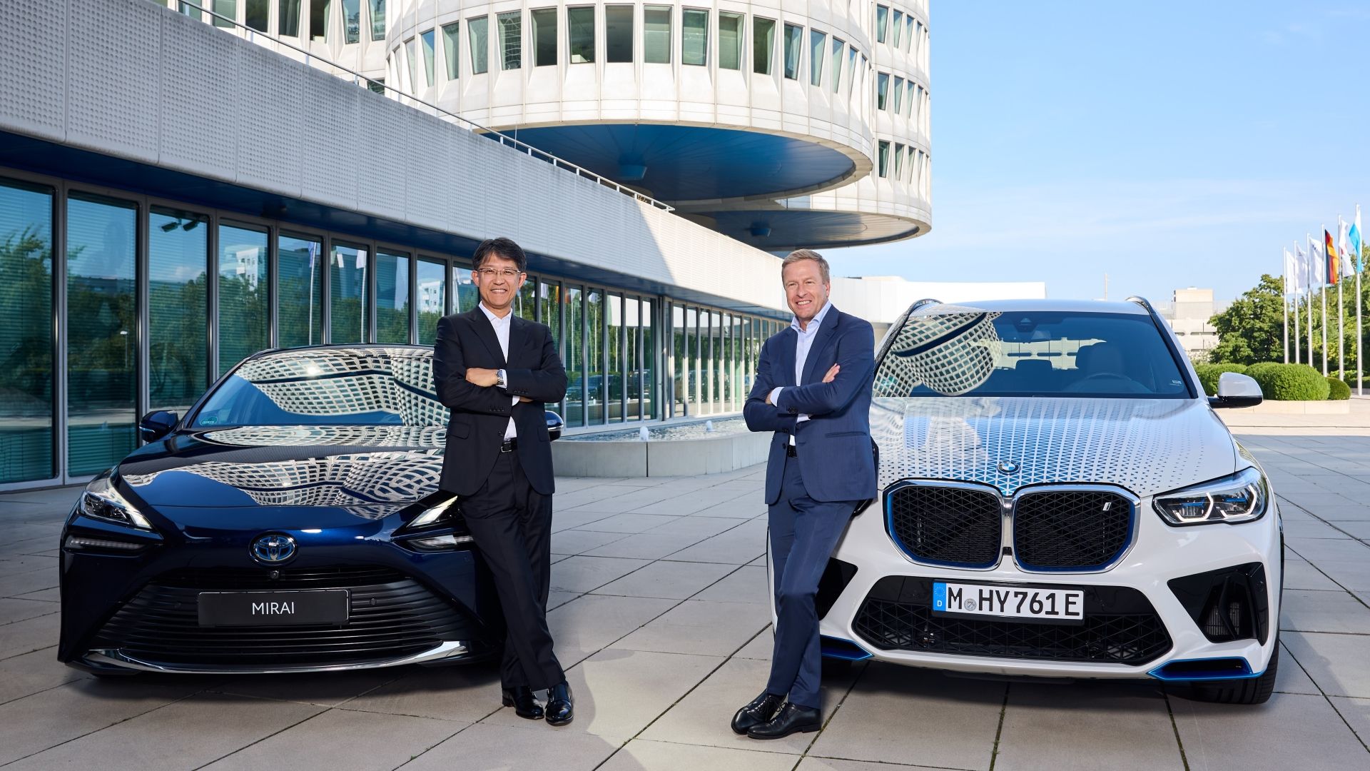 Toyota and BMW Presidents posing by their next-gen FCEVs