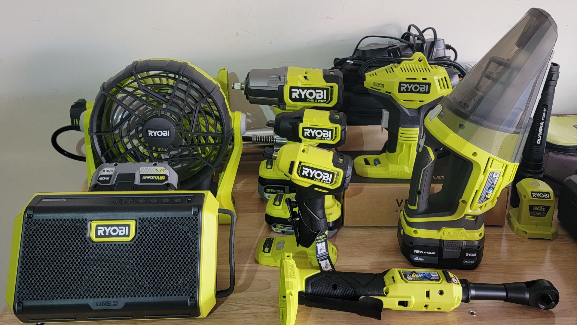 A bunch of Ryobi tools in a garage. 