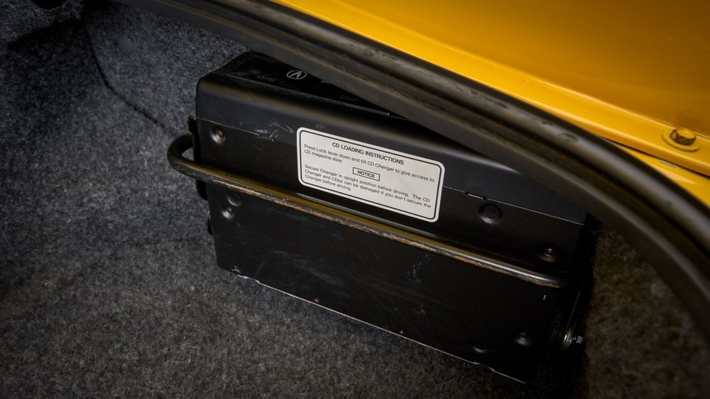 Yellow Acura NSX parked showing the cd changer.