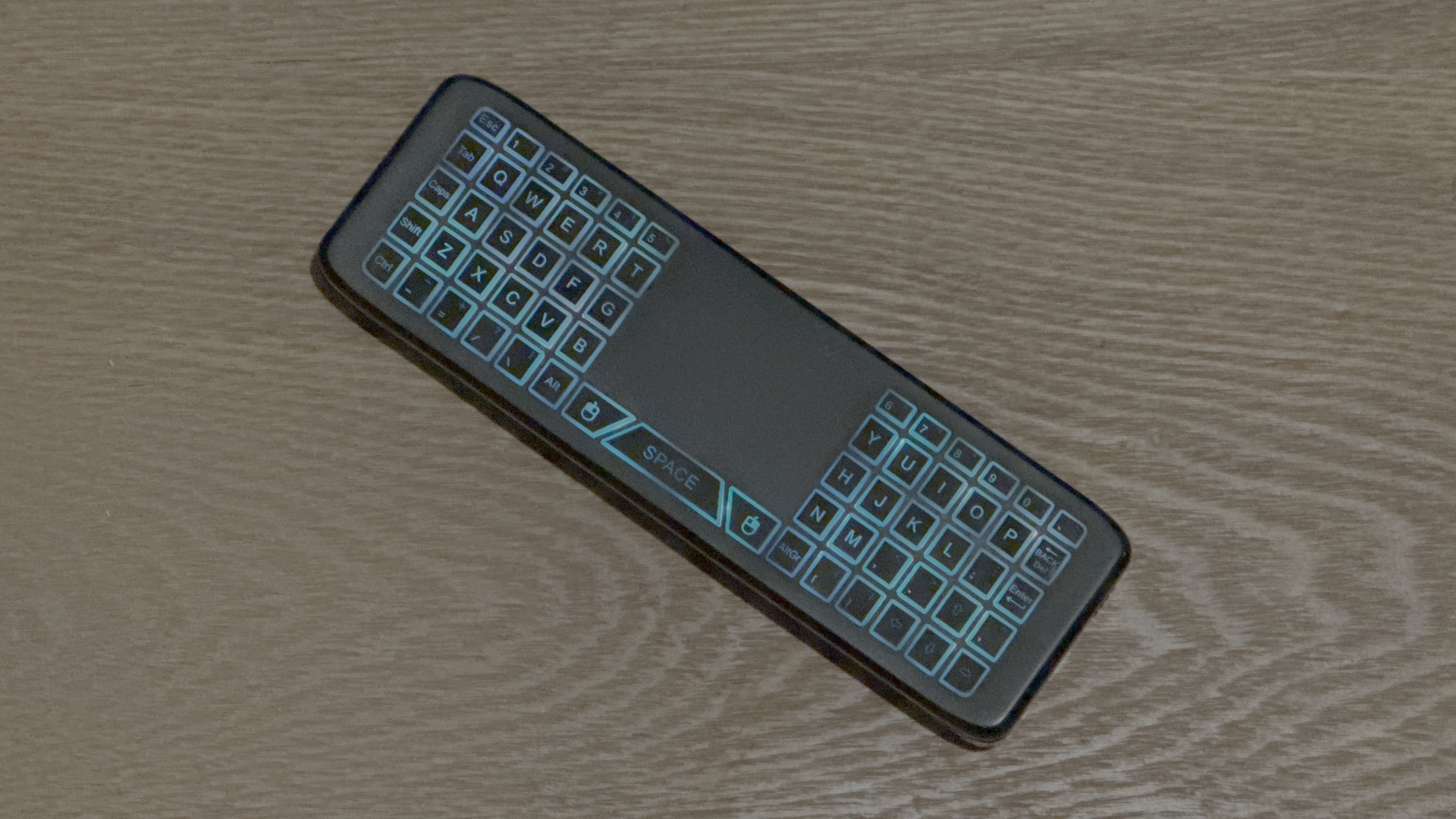 The back of a Maxdigi wireless air mouse and remote control showing the keyboard.