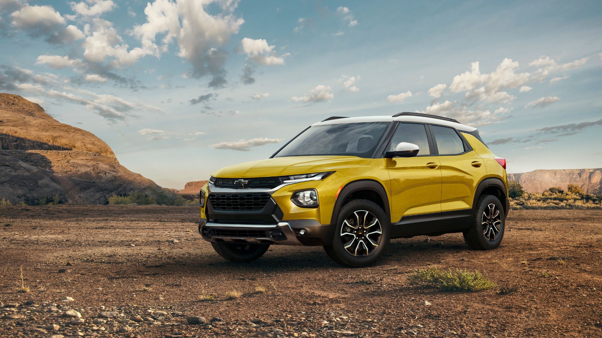 Front three-quarter view of a yellow 2023 Chevrolet Trailblazer parked in the desert.