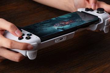 Person playing a game with a 8Bitdo controller.