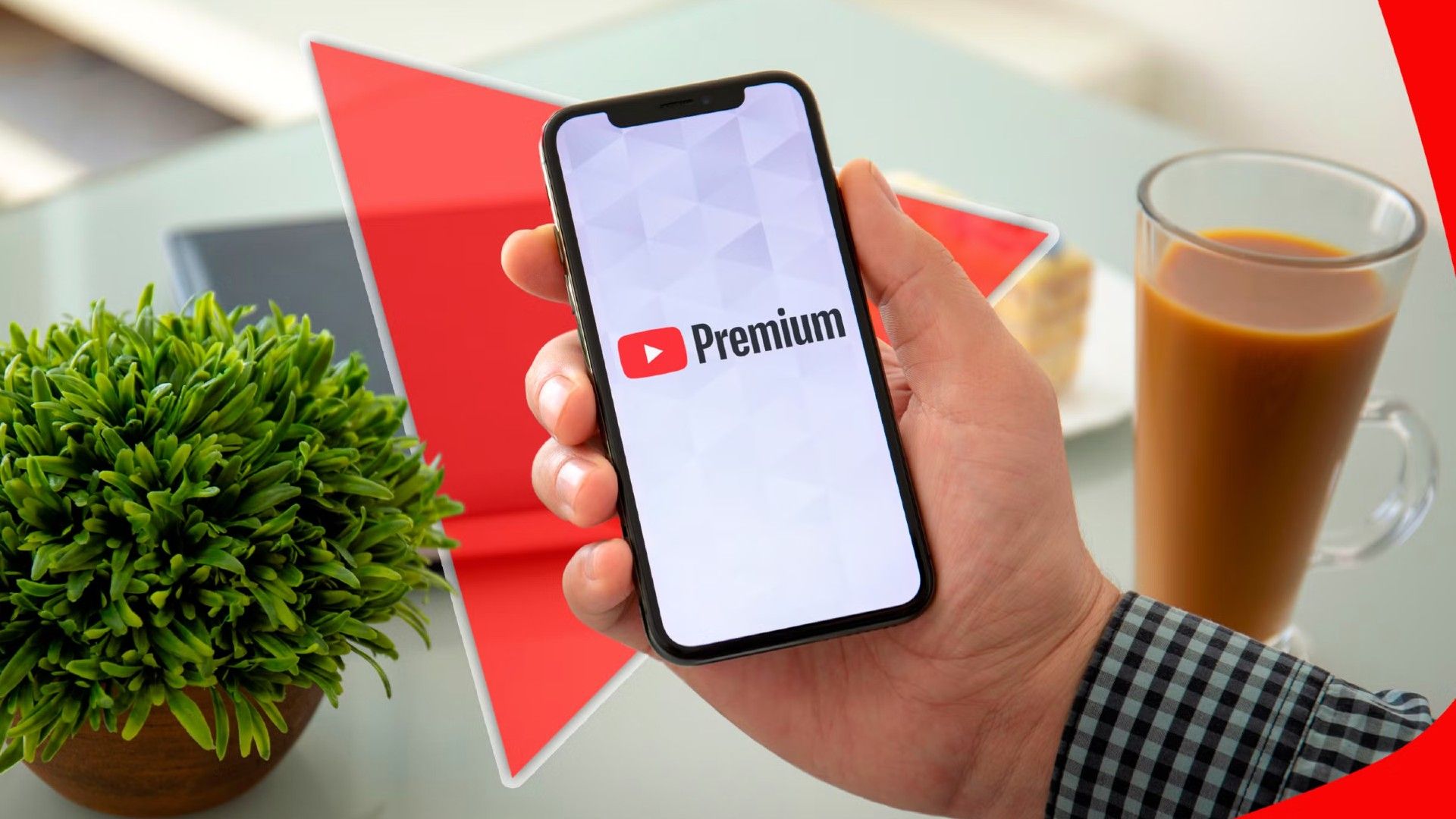 a hand holding a phone with youtube premium logo on the screen.