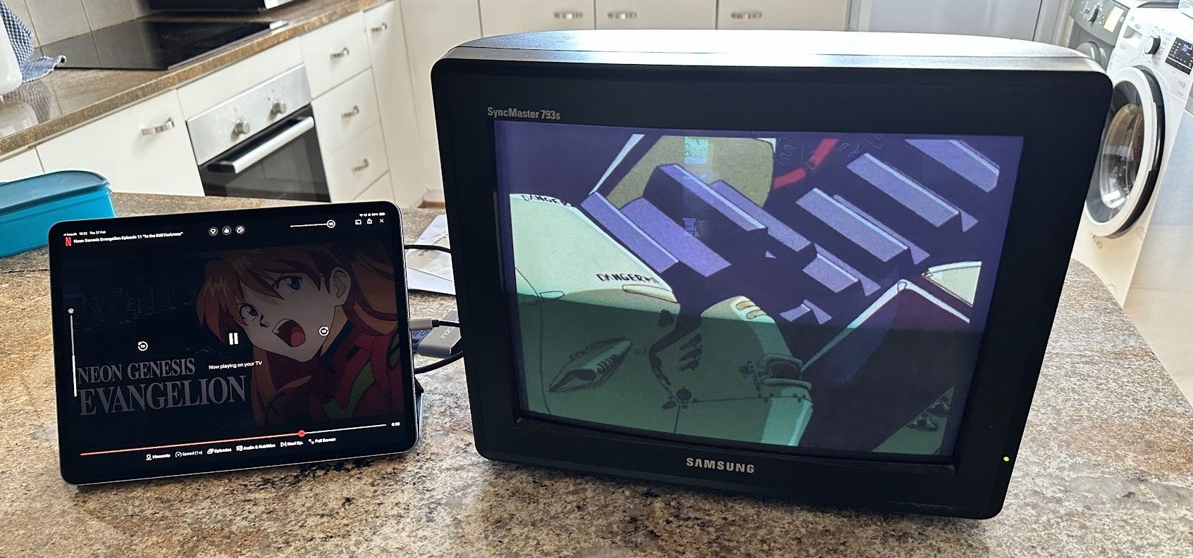 A Samsung Syncmaster monitor hooked up to an iPad playing an episode of Neon Genesis Evangelion