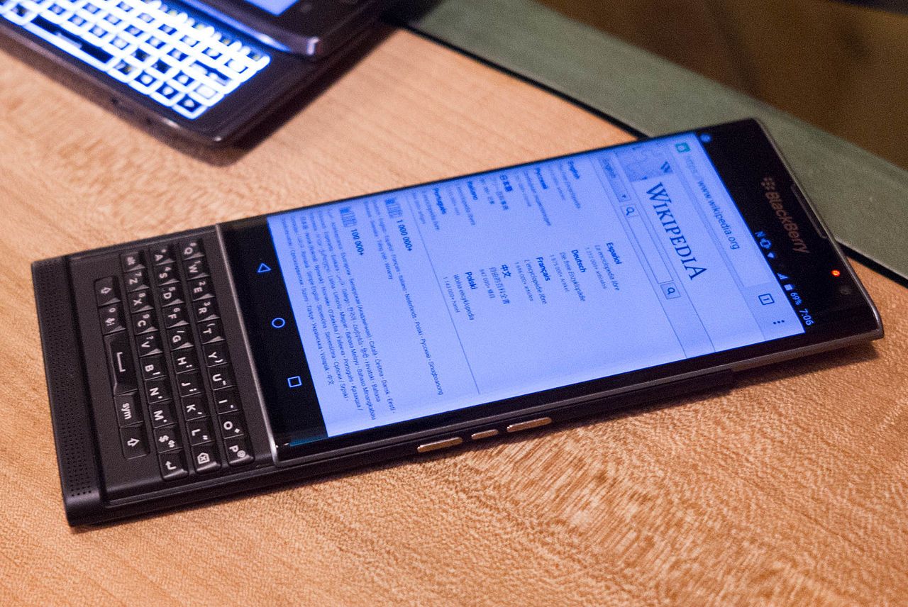 AT&T Blackberry Priv with Verizon Motorola Droid 4 in background.