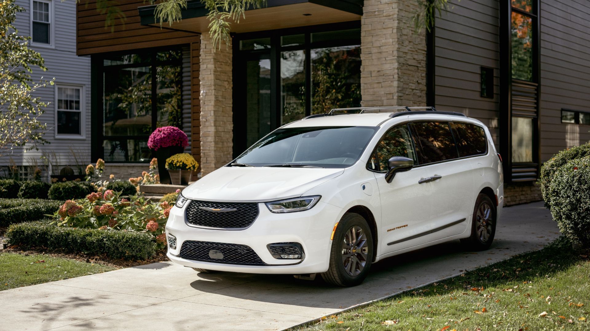 Front three-quarter view of a white 2023 Chrysler Pacifica parked on a driveway.