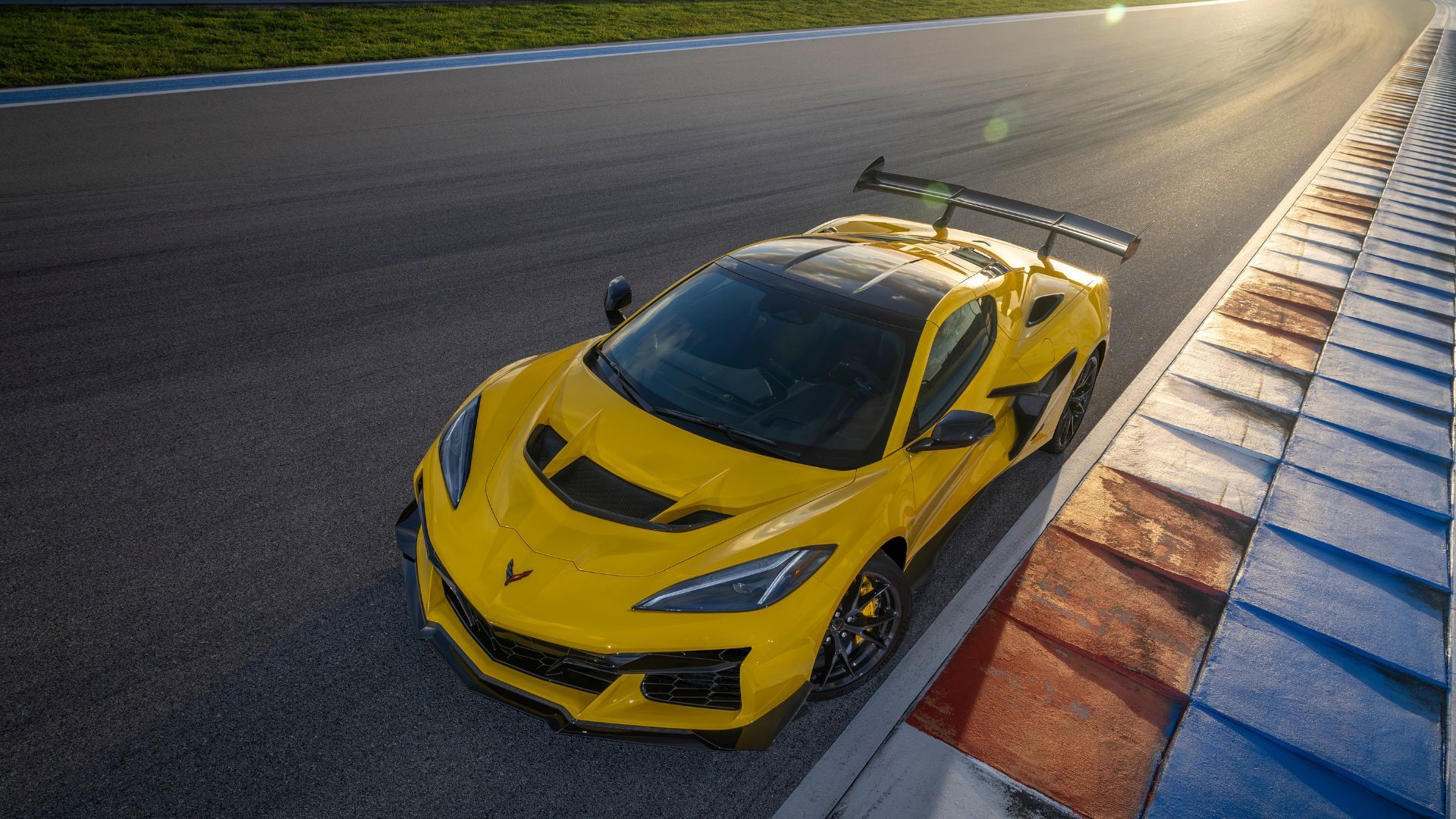 Full view of a yellow Chevrolet Corvette ZR1 Coupe pictures parked on a race track. 