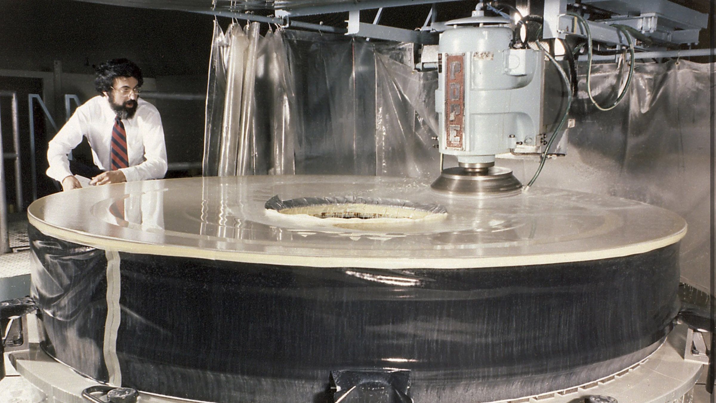 One of the mirrors of Hubble Telescope being ground in lab.