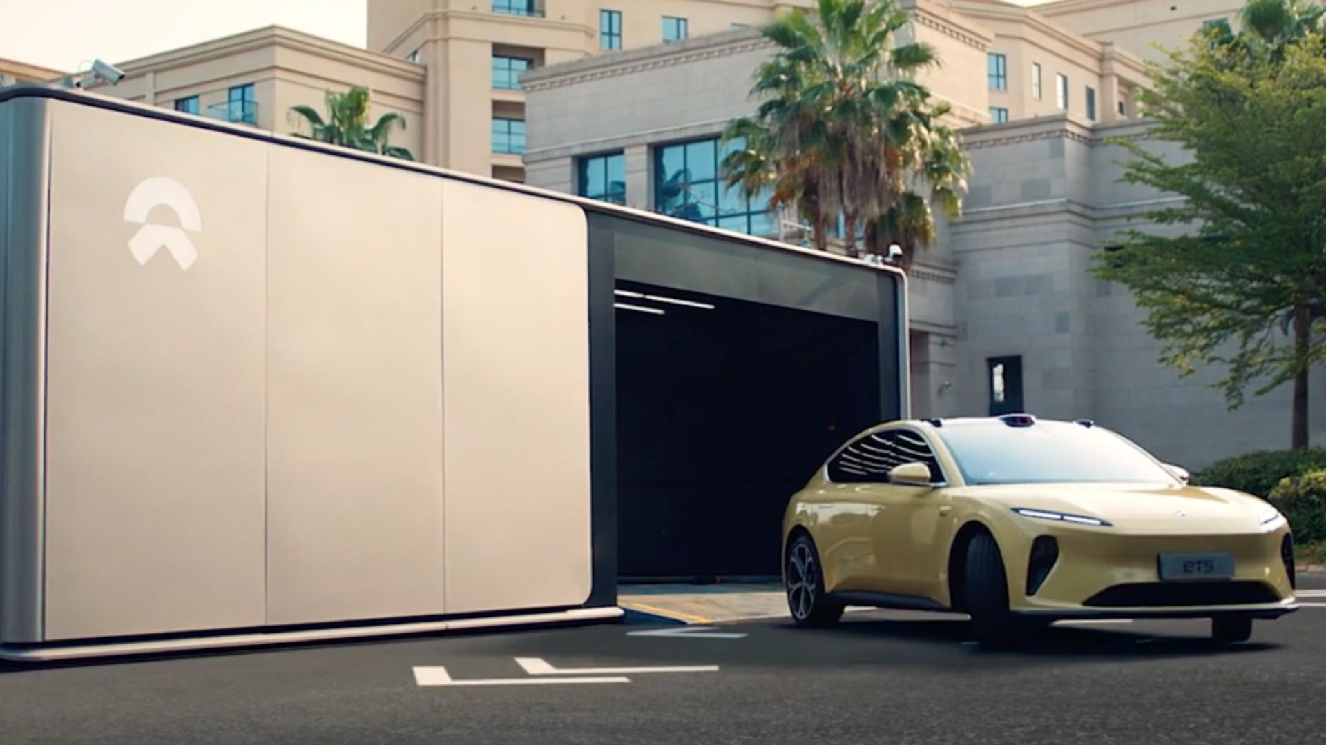 Full view of a NIO EV leaving a power station after a battery swap.