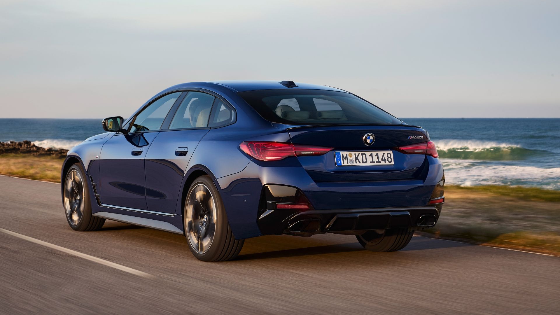 Rear 3/4 action shot of a 2025 BMW i4