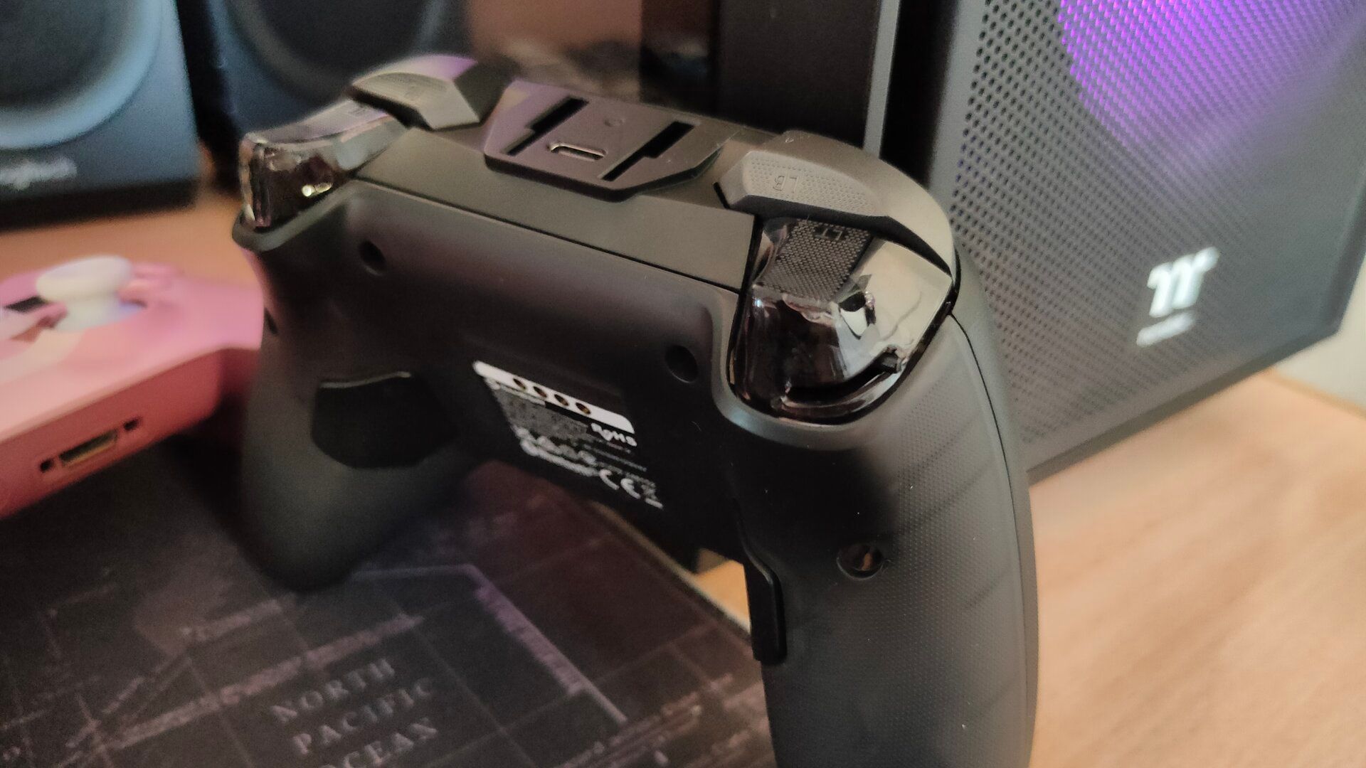 The GameSir Cyclone 2 controller with the trigger stop switch and rear paddles highlighted.