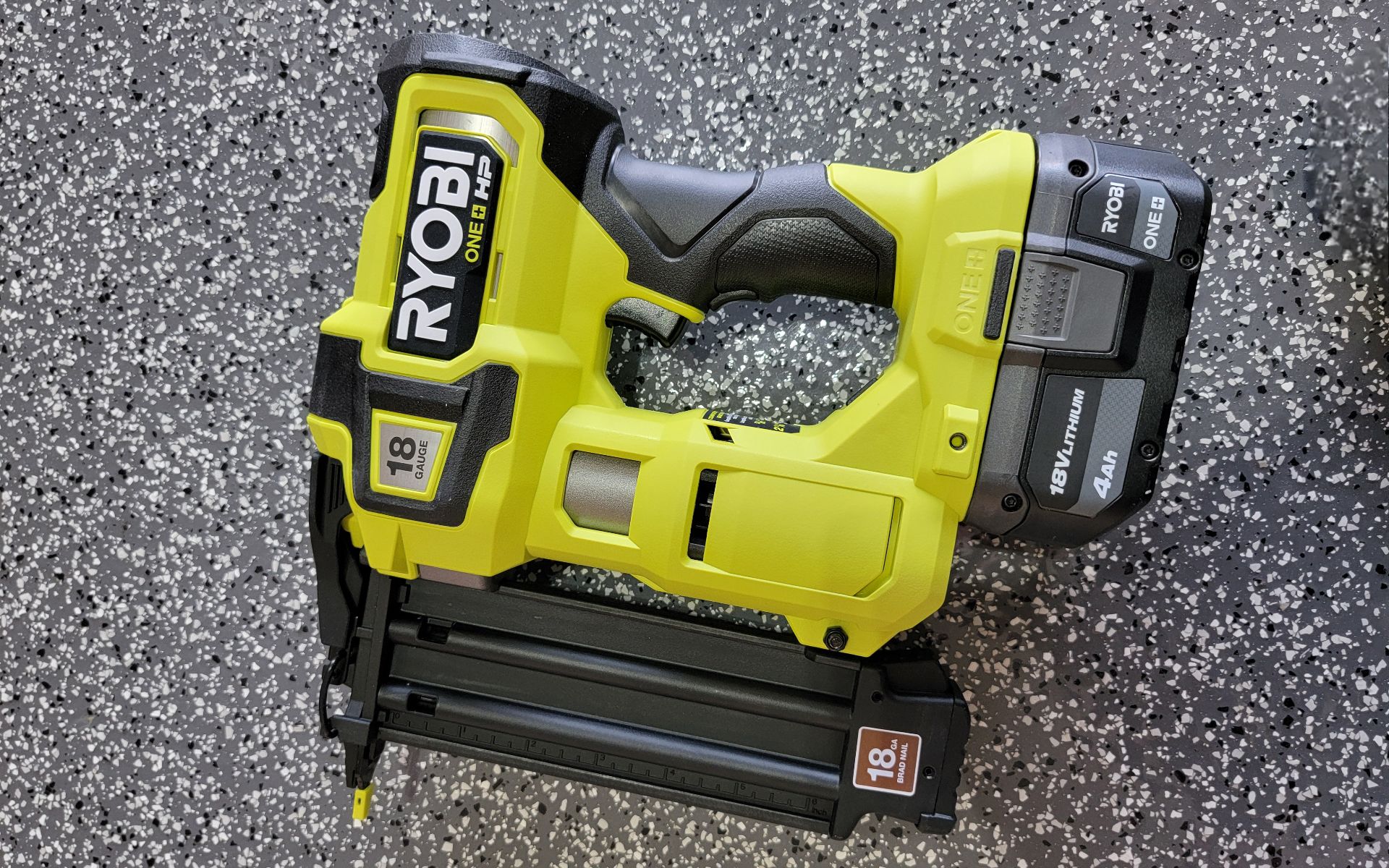 Ryobi brad nailer on a garage floor. 